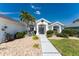 Front exterior of a home featuring decorative windows and lush landscaping at 12 Sportsman Ter, Rotonda West, FL 33947