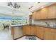Kitchen with granite countertops and views of the outdoor living space and lake at 12 Sportsman Ter, Rotonda West, FL 33947