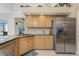 Well-lit kitchen featuring granite countertops, tile backsplash and stainless steel refrigerator at 12 Sportsman Ter, Rotonda West, FL 33947