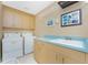Functional laundry room with washer, dryer, and ample cabinet space at 12 Sportsman Ter, Rotonda West, FL 33947