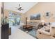Inviting living room with stylish decor, tile floors, and sliding glass doors to pool area at 12 Sportsman Ter, Rotonda West, FL 33947