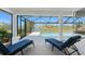Lanai with blue lounge chairs, pillars and screened enclosure with pond view at 12 Sportsman Ter, Rotonda West, FL 33947