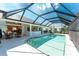 Screened-in pool with tiled steps and ample lounge space; perfect for relaxing at 12 Sportsman Ter, Rotonda West, FL 33947