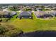 Beautiful aerial view of the rear exterior showcasing a screened-in pool and expansive green lawn at 12 Sportsman Ter, Rotonda West, FL 33947