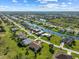 A stunning aerial view of canal-front homes in an attractive neighborhood with lush landscaping and canals at 127 White Marsh Ln, Rotonda West, FL 33947