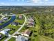 Scenic aerial view of a neighborhood with canal front homes and lush landscaping backing to native habitat at 127 White Marsh Ln, Rotonda West, FL 33947