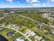 An aerial view shows residences in a community backing to protected land and a distant view of the city at 127 White Marsh Ln, Rotonda West, FL 33947