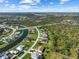 An aerial view shows residences in a community backing to protected land and a distant view of the city at 127 White Marsh Ln, Rotonda West, FL 33947