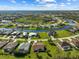 An aerial view shows a waterfront residential community with canals, landscaping, and well-maintained lawns at 127 White Marsh Ln, Rotonda West, FL 33947