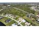 Aerial view of a neighborhood with a pond and surrounding forest at 127 White Marsh Ln, Rotonda West, FL 33947