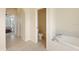 Bright bathroom featuring tile flooring, walk-in toilet and soaking tub at 127 White Marsh Ln, Rotonda West, FL 33947