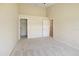 Spacious bedroom featuring carpet floors and multiple doorways to closets and other rooms at 127 White Marsh Ln, Rotonda West, FL 33947