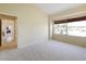 Spacious bedroom with carpet floors, large window, and a doorway to an adjacent room at 127 White Marsh Ln, Rotonda West, FL 33947