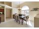 Bright dining area featuring a modern table set, large arched window, and decorative wall art at 127 White Marsh Ln, Rotonda West, FL 33947