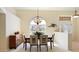 Elegant dining room with natural light, stylish chandelier, and ample space for entertaining guests at 127 White Marsh Ln, Rotonda West, FL 33947