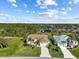 Beautiful single-story home boasts a well-manicured lawn, a long driveway, and mature landscaping at 127 White Marsh Ln, Rotonda West, FL 33947