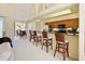 Open concept kitchen with bar seating, seamlessly connecting to the living and dining spaces at 127 White Marsh Ln, Rotonda West, FL 33947
