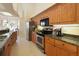 Modern kitchen featuring sleek appliances, granite countertops, and wood cabinetry at 127 White Marsh Ln, Rotonda West, FL 33947