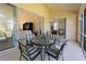 Enclosed lanai featuring comfortable seating and decor adjacent to the living area, ideal for relaxation at 127 White Marsh Ln, Rotonda West, FL 33947