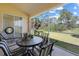 Enclosed lanai with seating area offers expansive views of the lush backyard and Florida landscape at 127 White Marsh Ln, Rotonda West, FL 33947