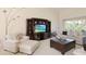 Comfortable living room with plush seating, built-in entertainment center, and serene outdoor views at 127 White Marsh Ln, Rotonda West, FL 33947