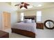 Spacious main bedroom features a ceiling fan, windows, and stylish furniture at 127 White Marsh Ln, Rotonda West, FL 33947