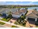Aerial view of a home with a well-manicured lawn and a brick-paved driveway at 13137 Oriago St, Venice, FL 34293