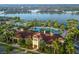 Stunning aerial view of community clubhouse, pools, and lakefront homes in a tropical setting at 13137 Oriago St, Venice, FL 34293