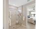 Modern bathroom featuring a glass enclosed shower with tiled walls, bench, and view to bedroom at 13137 Oriago St, Venice, FL 34293