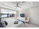 Bright bedroom features a tray ceiling, a ceiling fan and an ensuite with serene lake views at 13137 Oriago St, Venice, FL 34293