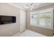 Cozy room with a white door, and a window with white shutters and a mounted tv at 13137 Oriago St, Venice, FL 34293