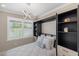 Stylish bedroom features a murphy bed, and shelving at 13137 Oriago St, Venice, FL 34293