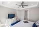 Bedroom featuring neutral walls, modern ceiling fan, and a dresser with a TV for entertainment at 13137 Oriago St, Venice, FL 34293