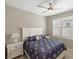 Comfortable bedroom featuring a ceiling fan and window with plantation shutters at 13137 Oriago St, Venice, FL 34293