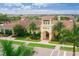 Community clubhouse surrounded by lush landscaping, palm trees, and well-manicured gardens at 13137 Oriago St, Venice, FL 34293