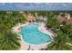 A beautiful community pool with a zero entry, plenty of swimmers and sun loungers, and lush landscaping at 13137 Oriago St, Venice, FL 34293