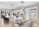 Elegant dining area boasts modern lighting, open access to living room, and views of the lake at 13137 Oriago St, Venice, FL 34293