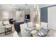 Dining area next to the kitchen and living room with stylish light fixture and white chairs at 13137 Oriago St, Venice, FL 34293