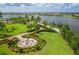 Aerial view of a cozy community fire pit with seating area surrounded by lush landscaping at 13137 Oriago St, Venice, FL 34293