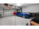 Clean and spacious garage with a blue sports car and ample storage space at 13137 Oriago St, Venice, FL 34293