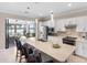 Bright kitchen with a spacious island, white cabinets, stainless steel appliances, and access to outdoor space at 13137 Oriago St, Venice, FL 34293