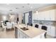 Spacious kitchen with a large island, white cabinetry, stainless steel appliances, and an open floor plan at 13137 Oriago St, Venice, FL 34293