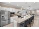 Bright kitchen featuring a center island, stainless appliances, and an open concept to the living and dining area at 13137 Oriago St, Venice, FL 34293