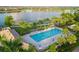 Aerial view of a well-maintained community lap pool with lane markers and ample lounging space at 13137 Oriago St, Venice, FL 34293
