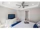 This main bedroom features a ceiling fan, a view of the water, a television and white trim at 13137 Oriago St, Venice, FL 34293