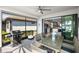 Outdoor patio with a grill, dining table, and an open view to the modern kitchen and backyard at 13137 Oriago St, Venice, FL 34293