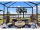 Relaxing screened-in patio with comfortable seating and peaceful lake views, perfect for outdoor entertaining at 13137 Oriago St, Venice, FL 34293