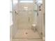 Large glass shower features a bench, hand-held sprayer, and decorative tile accents at 13137 Oriago St, Venice, FL 34293