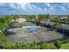 Multiple outdoor tennis courts with shade pavilions in a lush, tropical community setting, perfect for an active lifestyle at 13137 Oriago St, Venice, FL 34293