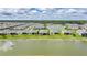Homes backing onto a lake, surrounded by lush landscaping and natural beauty at 1409 Remington Trace Dr, Port Charlotte, FL 33953
